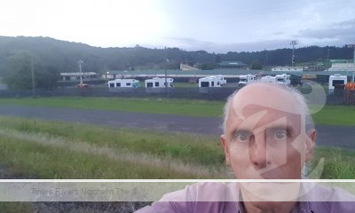 Health researcher Dr Eric van Beurden with Lismore RV Covid contact accomodation abutting the weekly market sheds.