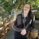 A photo of Denise Galle leaning on a bridge.