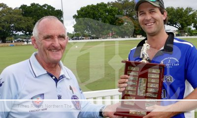 Cricket umpire shaking hands with a winner.