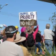 Protestor holding a sign at Woodburn Bridge