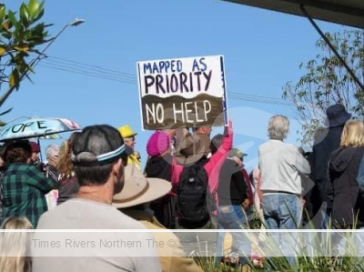 Protestor holding a sign at Woodburn Bridge