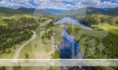 A Birds Eye view of a river with running water and hills beside it.