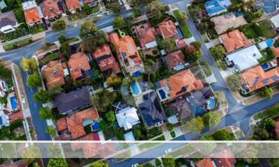Drone shot of roofs of suburban households with rental pain indexes.
