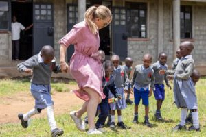 Women running with young children in Kenya