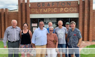 a group of residents standing in front of the grafton pool.