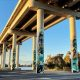 Under a bridge with art work on the pillars.