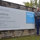 Mickey Sahni GM Bupa Ballina standing in front of the Bupa Ballina sign.