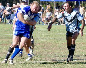 Grafton Ghosts player coach Adam Slater tries to power through the Woolgoolga defence with a typically robust carry during the qualifying final at Woolgoolga on Sunday.