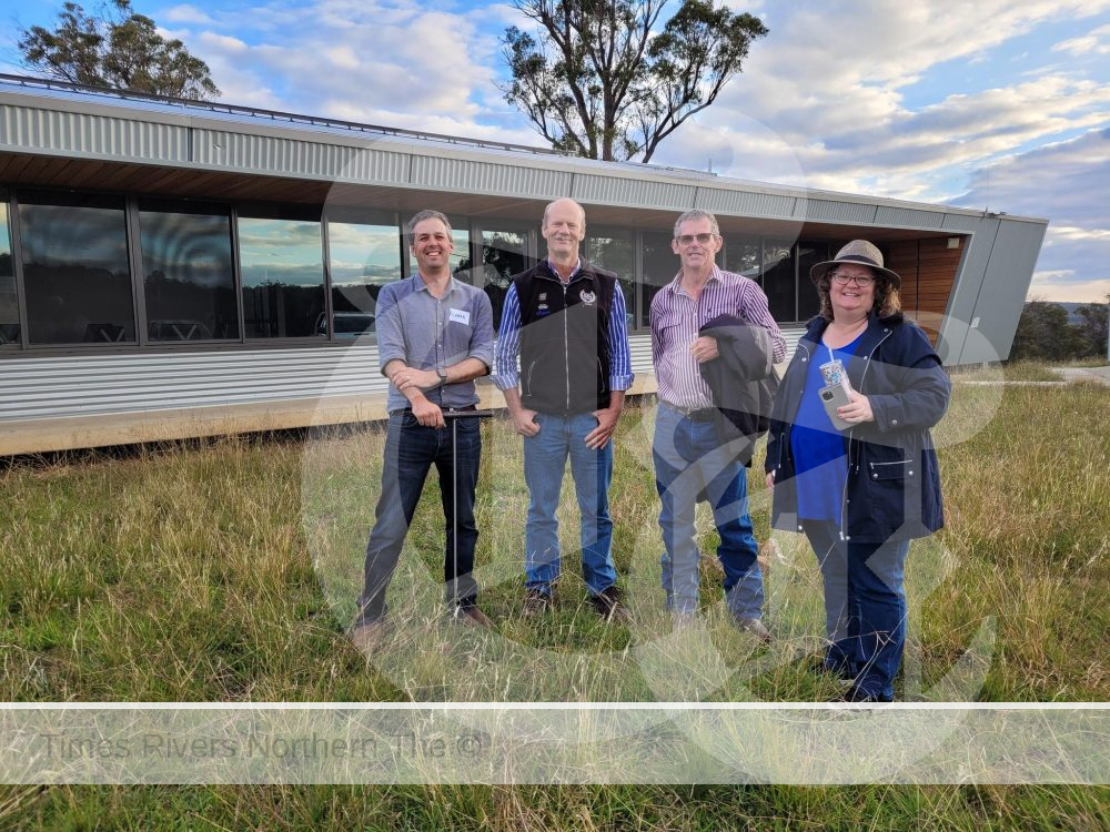 A group of people in front of a farmhouse