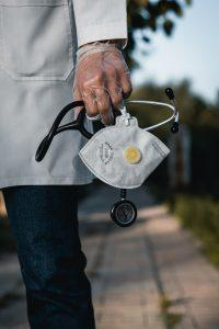 A rural health doctor holding medical supplies as the voice of rural health.