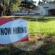 A now hiring sign as unemployment hits a high