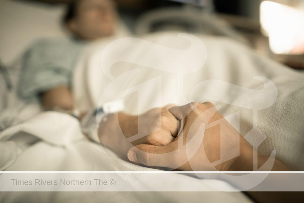 Man holding a womens hand struggling with cancers unseen side effects.