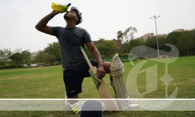 Cricket player drinking water due high body temperature in hot weather.