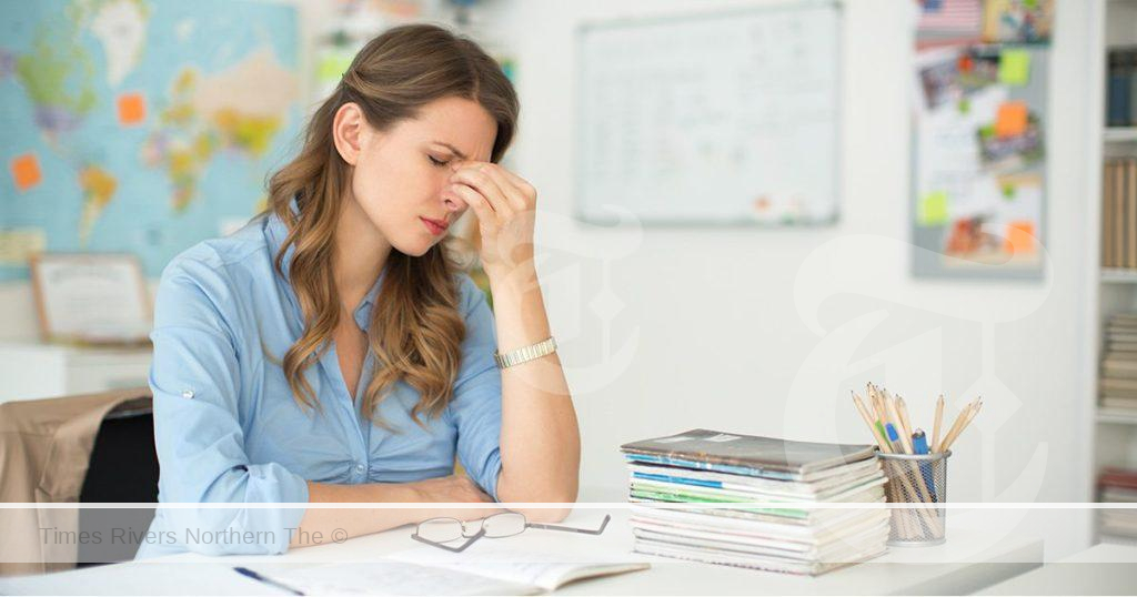 A teacher struggling with their workload after nor receiving a pay rise