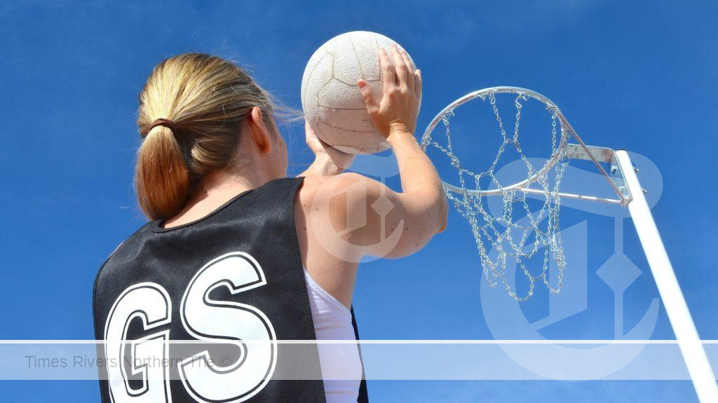 A girl playing netball with level playing field for women in sport.