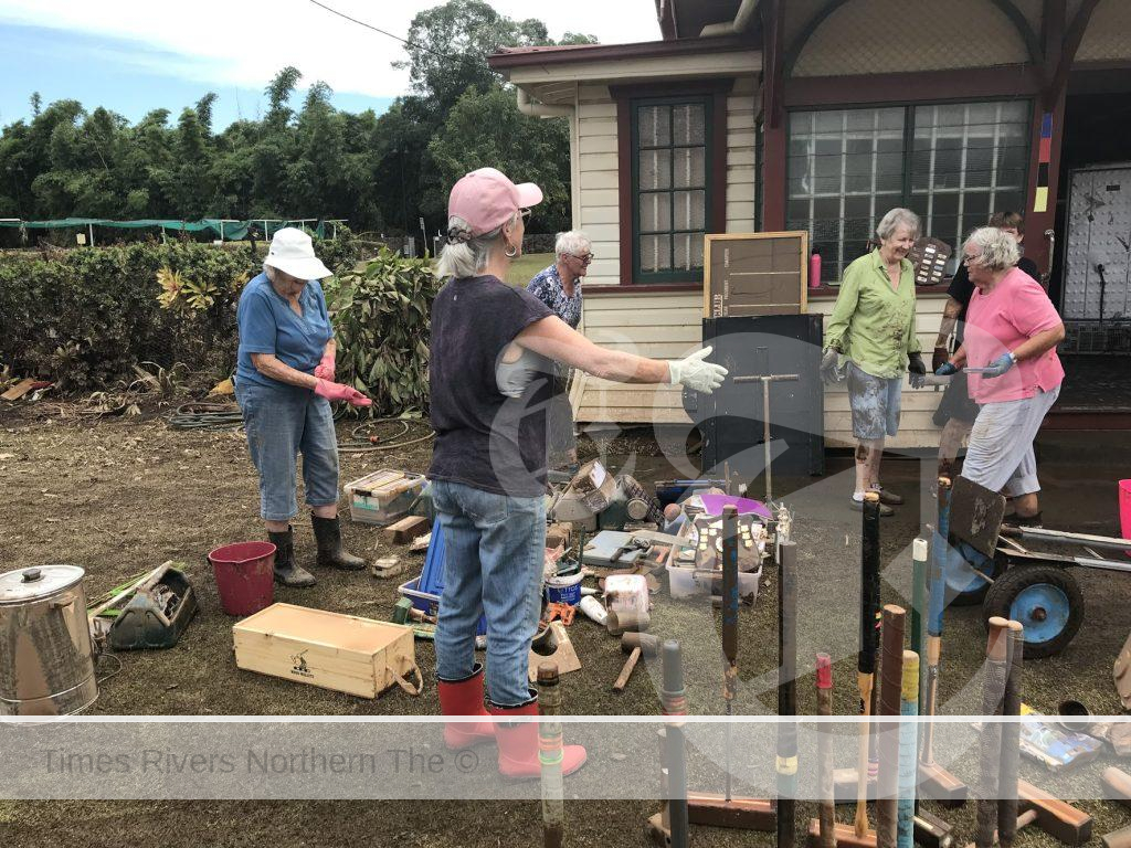 Cleaning up the area after the flood at the Lismore Croquet Club.