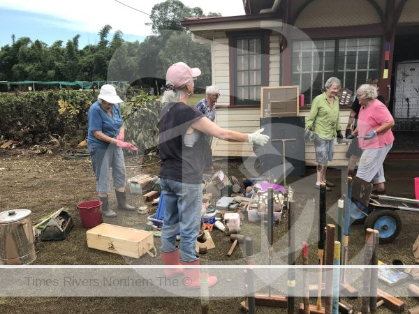 Cleaning up the area after the flood at the Lismore Croquet Club.