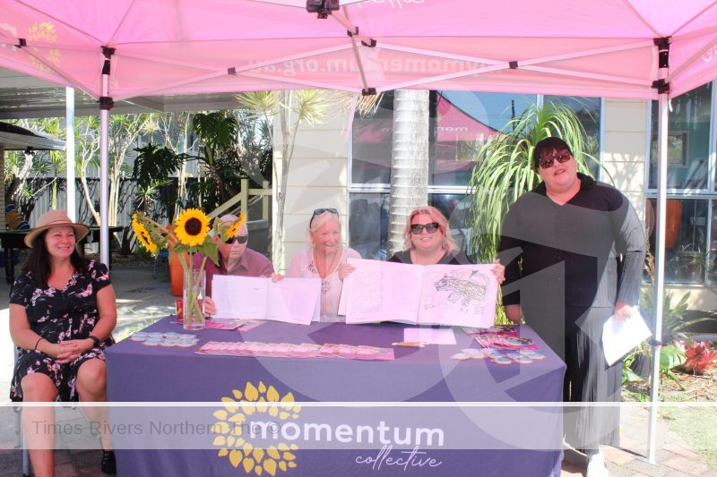 Momentum Collective at a market stall selling there book in honour of mental health awareness month.