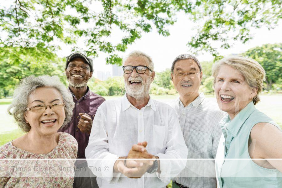 A group of pensioners excited as their pension has increased showing a positive aspect of inflation.