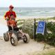 Kyle Sculley, member of the Tweed Equal Access Advisory Committee and Jayden, Cudgen Headland Lifeguard, at Kingscliff Beach. Kyle is using the all-terrain wheelchair with Jayden assisting to drive it over beach matting.