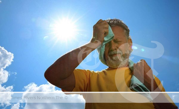 A man staying sun safe while gardening in the heat.