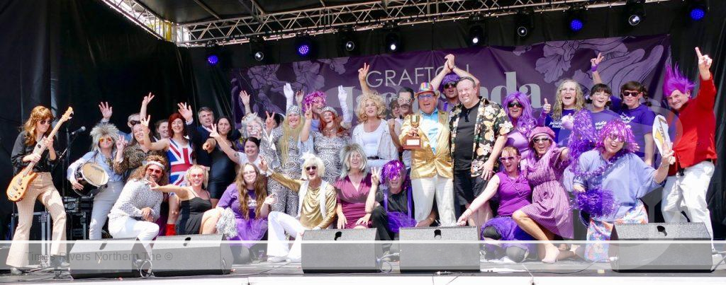 Holding the Jacaranda Gold Cup for a second year in a row, the Clarence Valley Council cast celebrate their win stage on Thursday.