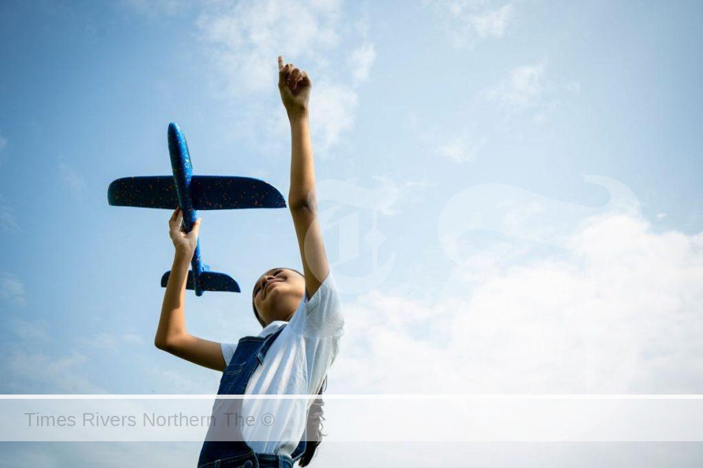 Elevating Support for Women in Aviation Careers - Women in the Aviation Industry Initiative young girl holding a fake plane