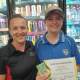 Erin Witton of North Casino Mini Mart presents hero Izzy Miller with a certificate and $100 after stopping a bus crash in casino.