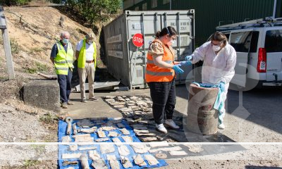 Council staff, accompanied by John Henley and Garry Smith - former members of the community service organisation Apex - examine the contents of Murwillumbah's community time capsule placed by Apex in 1973.