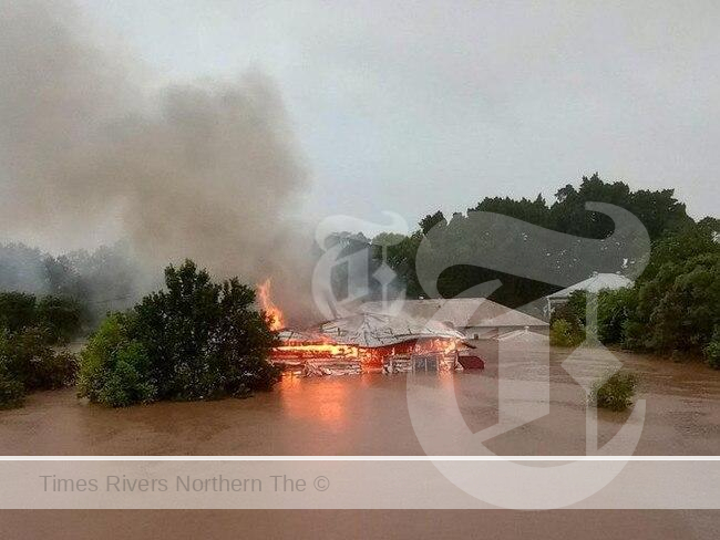 a home on fire due to Forced relocation due to fire and flood risks