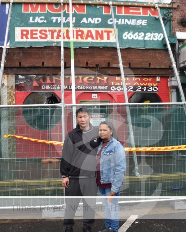 Paul Wu and Kristina NHen out the front of what's left of their Mun-Tien restaurant damged by the Casino fire last month.