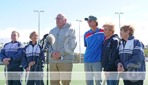 Mayor Steve Krieg and Far North Coast Hockey President Nathan Kesteven flanked by local competitors in the NSW Women's Masters Hockey Championships