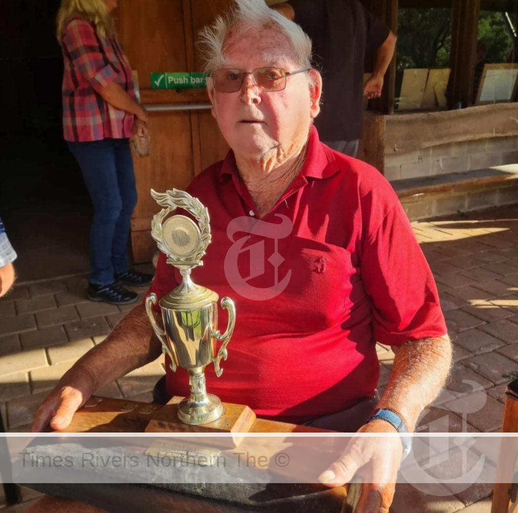 Frank Fletcher holding Fletcher Memorial Trophy for annual cricket match held each year on Queens Birthday, now King's Birthday weekend in June.