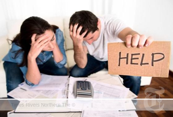 A struggling couple holding a help sign for rate relief