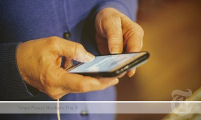 A senior reading the Easy Read Hub Format on her mobile phone