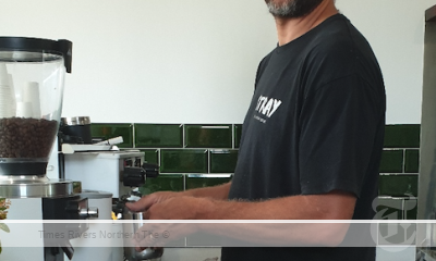 Damo Robertson, owner of Little Stray, behind the coffee machine in Woodburn.