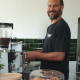 Damo Robertson, owner of Little Stray, behind the coffee machine in Woodburn.